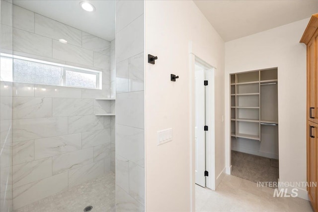 full bathroom featuring a spacious closet, a walk in shower, and recessed lighting