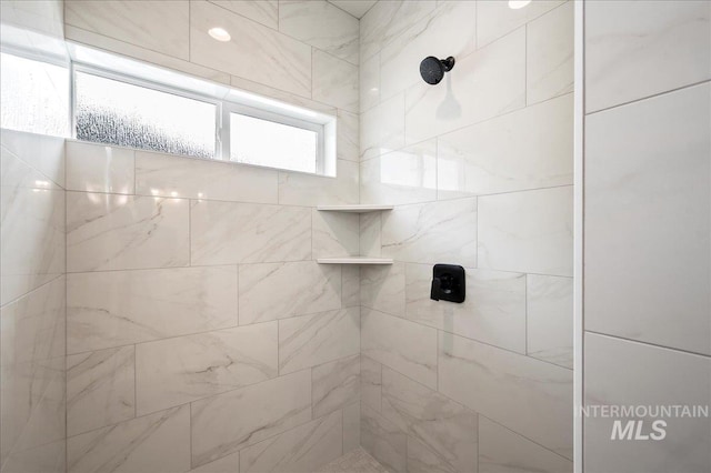 full bath with a tile shower