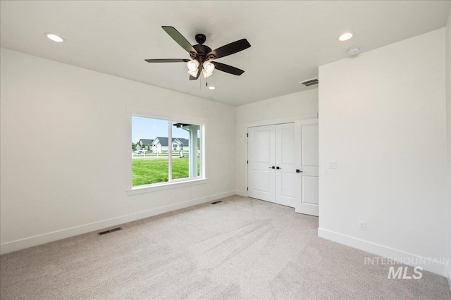 unfurnished bedroom featuring recessed lighting, baseboards, visible vents, and light colored carpet