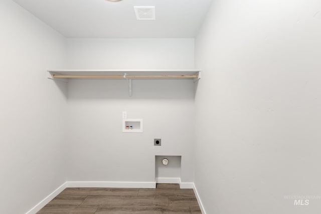 clothes washing area featuring dark hardwood / wood-style flooring, hookup for a washing machine, and hookup for an electric dryer