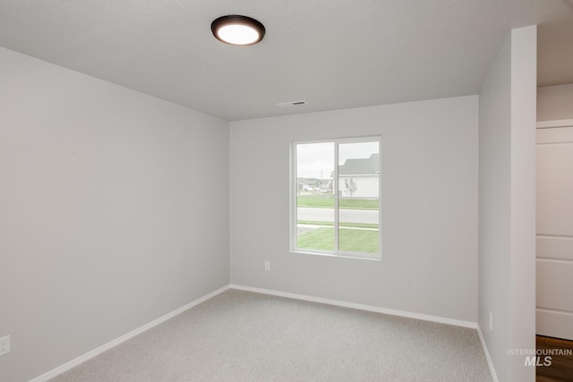 spare room featuring carpet floors