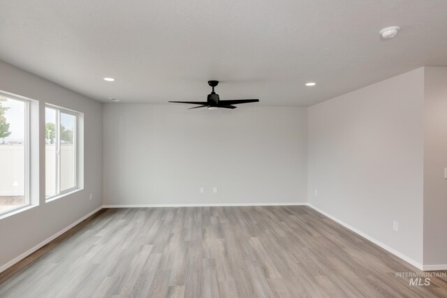 unfurnished room with ceiling fan and light hardwood / wood-style flooring