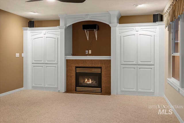 2920 S Givens Way, Meridian, ID 83642 - unfurnished living room featuring carpet floors, a tiled fireplace, and baseboards