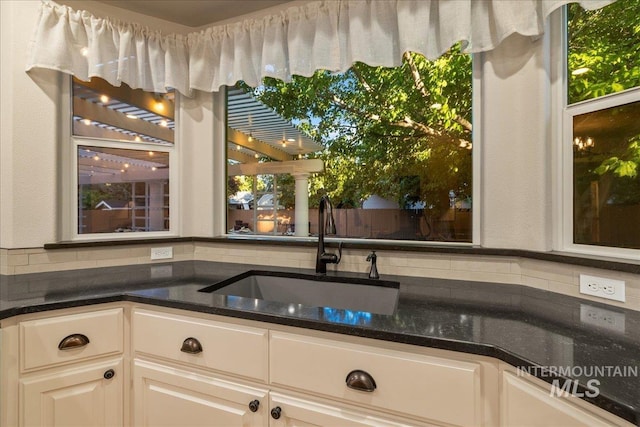 2920 S Givens Way, Meridian, ID 83642 - kitchen featuring a sink, tasteful backsplash, and dark stone countertops