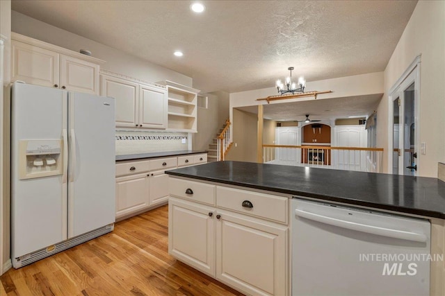 2920 S Givens Way, Meridian, ID 83642 - kitchen with white appliances, a chandelier, light wood-style flooring, dark countertops, and a ceiling fan
