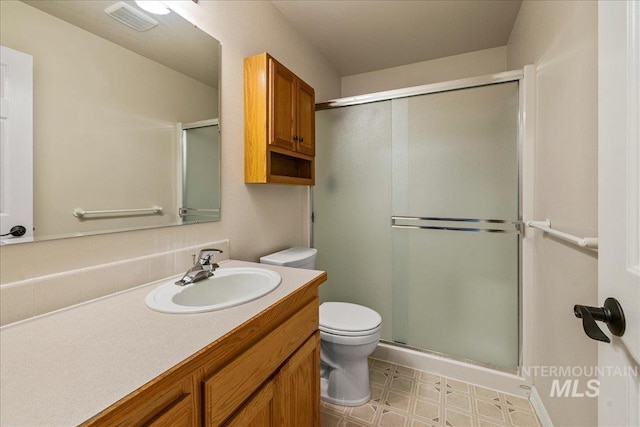 2920 S Givens Way, Meridian, ID 83642 - bathroom with a shower stall, toilet, tile patterned floors, and vanity