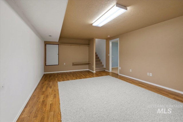 2920 S Givens Way, Meridian, ID 83642 - empty room featuring wood finished floors, stairs, baseboards, and a textured ceiling