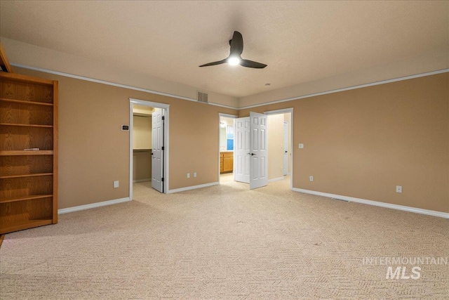 2920 S Givens Way, Meridian, ID 83642 - unfurnished bedroom featuring light colored carpet, a spacious closet, baseboards, ensuite bath, and a ceiling fan