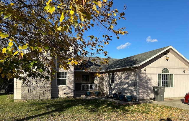 view of side of home featuring a yard