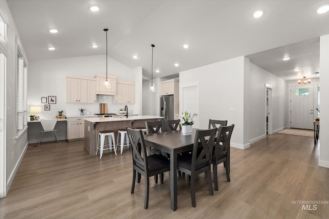 1866 W Windswept Dr, Meridian, ID 83646 - dining room featuring vaulted ceiling, light wood finished floors, and recessed lighting