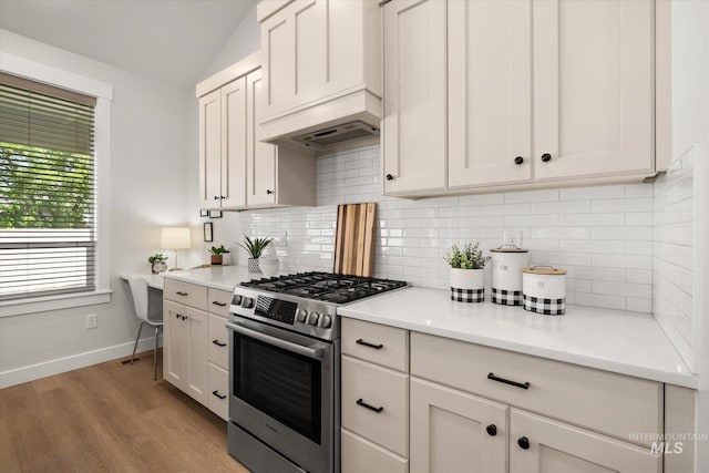 1866 W Windswept Dr, Meridian, ID 83646 - kitchen featuring stainless steel gas range oven, lofted ceiling, decorative backsplash, light countertops, and light wood finished floors