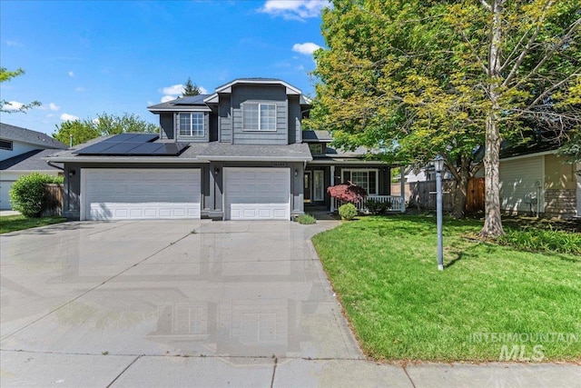 traditional home with solar panels, driveway, and a garage