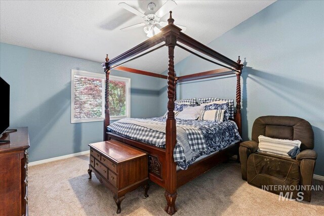 carpeted bedroom with a ceiling fan, baseboards, and lofted ceiling