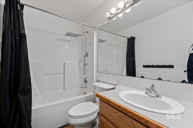 bathroom featuring tasteful backsplash, toilet, shower / bath combo, and vanity