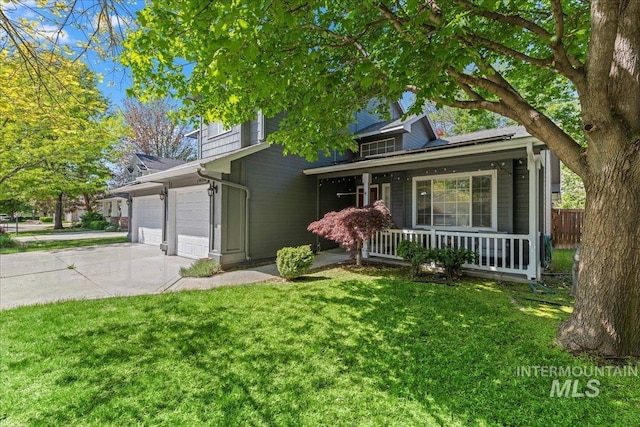 view of front of home featuring covered porch, concrete driveway, and an attached garage