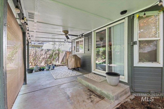 view of patio / terrace with fence and ceiling fan