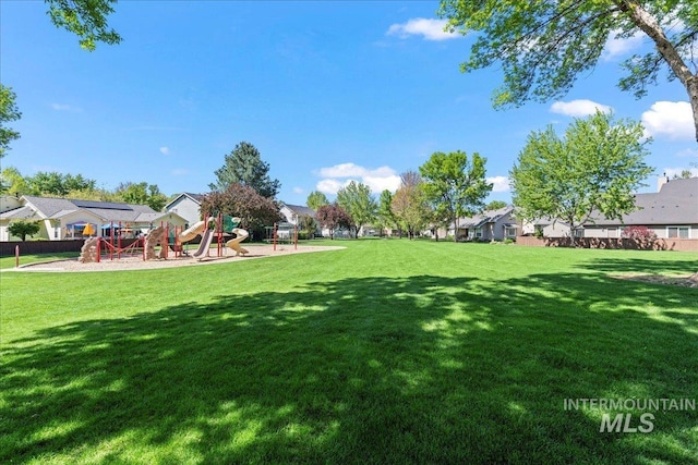 view of green lawn with a residential view