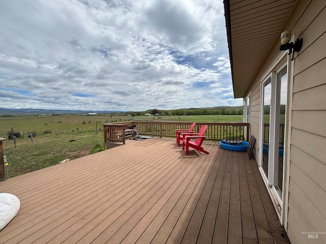 wooden terrace featuring a rural view