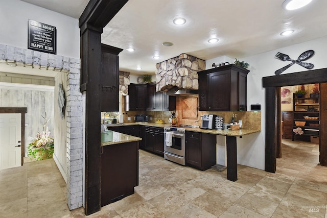 kitchen with tasteful backsplash, dark brown cabinets, and stainless steel range