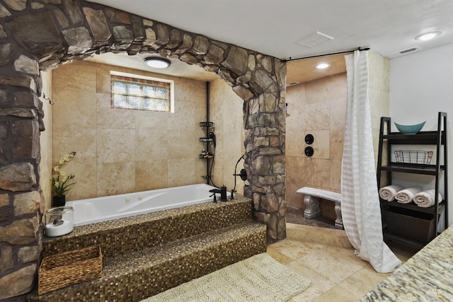 bathroom featuring a relaxing tiled tub