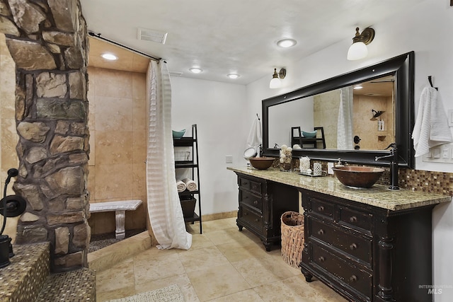 bathroom featuring tile patterned flooring and vanity