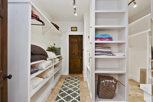 walk in closet featuring radiator