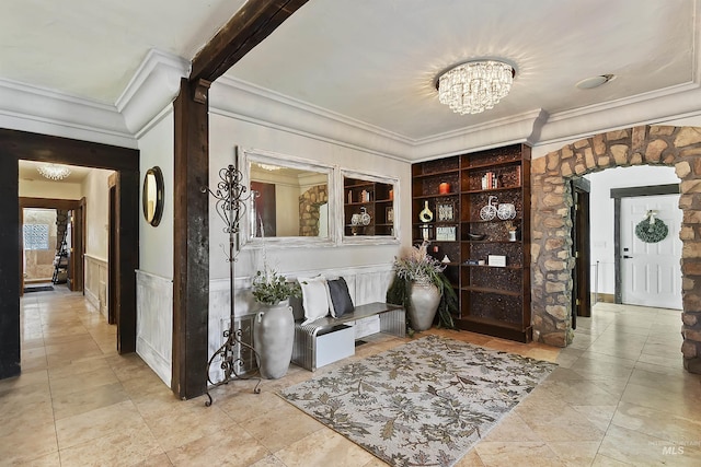 hall with an inviting chandelier and crown molding