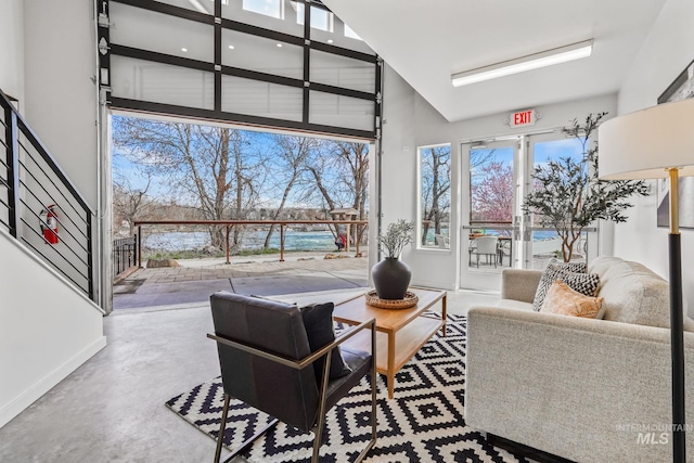 3472 N Prospect Ln, Garden City, ID 83714 - interior space with baseboards, a high ceiling, and concrete flooring