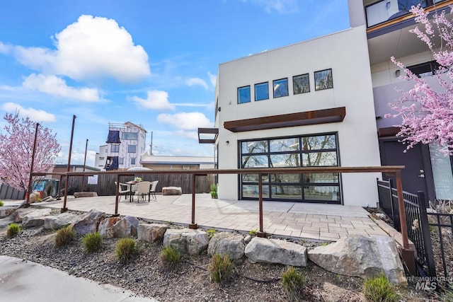 3472 N Prospect Ln, Garden City, ID 83714 - rear view of property featuring fence, stucco siding, and a patio area