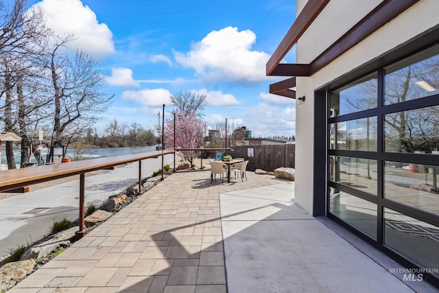 3472 N Prospect Ln, Garden City, ID 83714 - view of patio with a water view, outdoor dining area, and fence