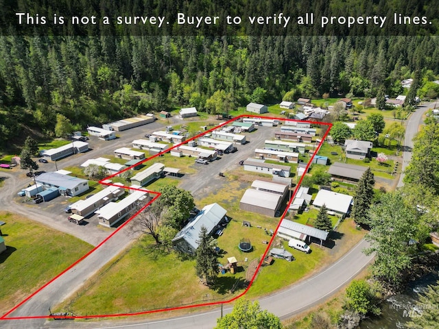 aerial view of property's location featuring property boundaries highlighted and a forest