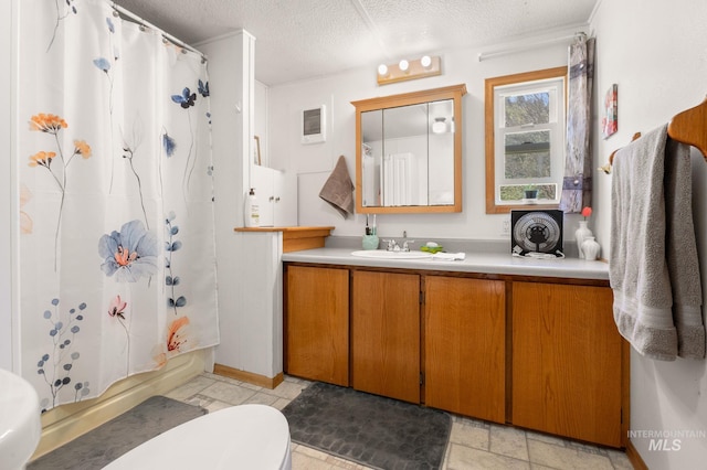 full bathroom with a textured ceiling, toilet, vanity, and shower / bath combination with curtain