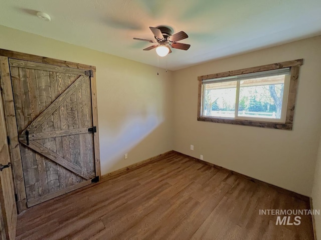 13974 Rustic Rd, Mccall, ID 83638 - unfurnished bedroom with wood finished floors, baseboards, and ceiling fan