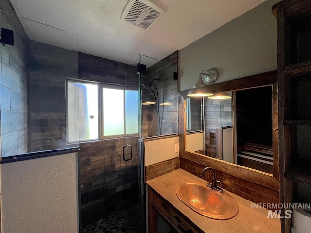 13974 Rustic Rd, Mccall, ID 83638 - bathroom featuring a stall shower, vanity, and tasteful backsplash