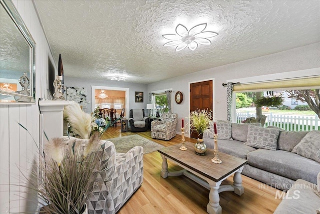 414 S 18th Ave, Caldwell, ID 83605 - living room with wood finished floors, healthy amount of natural light, and a textured ceiling