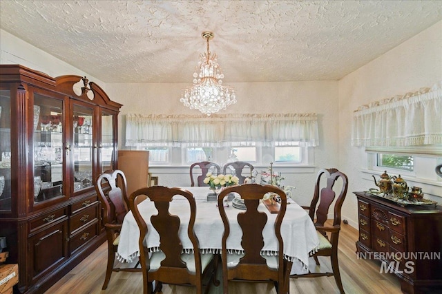 414 S 18th Ave, Caldwell, ID 83605 - dining space with a textured ceiling, light wood finished floors, and a chandelier