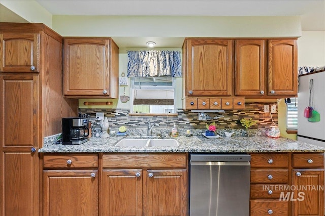 414 S 18th Ave, Caldwell, ID 83605 - kitchen featuring dishwasher, a sink, plenty of natural light, and light stone countertops