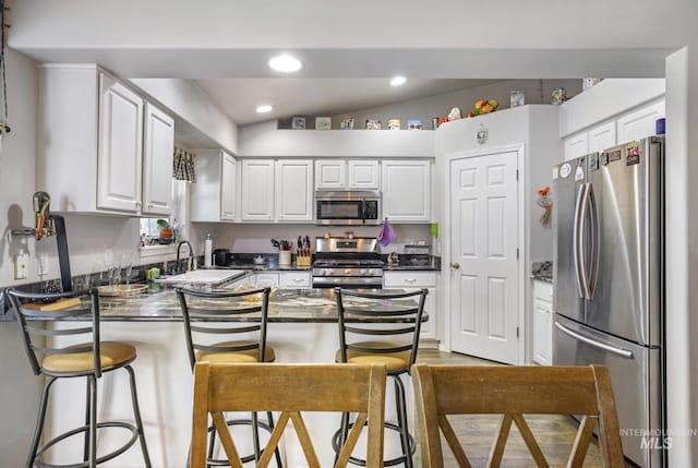 265 Cedar Park Cir, Twin Falls, ID 83301 - kitchen with a sink, white cabinets, a peninsula, and stainless steel appliances
