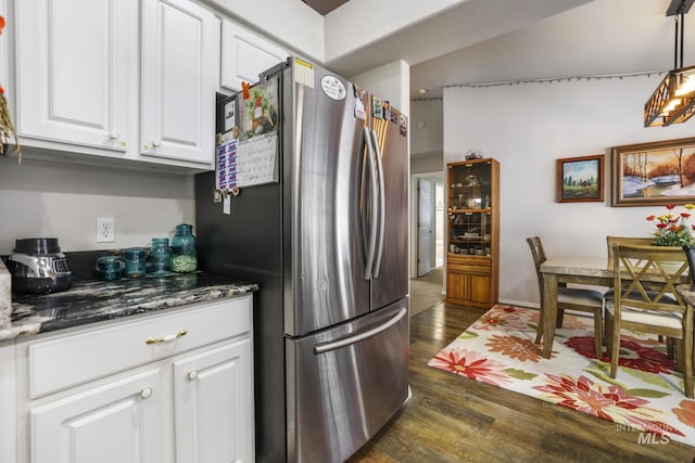 265 Cedar Park Cir, Twin Falls, ID 83301 - kitchen with white cabinets, freestanding refrigerator, dark stone counters, decorative light fixtures, and dark wood-style flooring