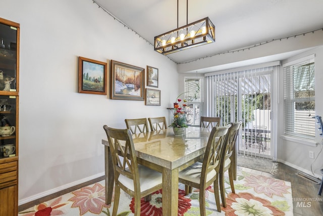 265 Cedar Park Cir, Twin Falls, ID 83301 - dining space featuring baseboards, wood finished floors, and an inviting chandelier