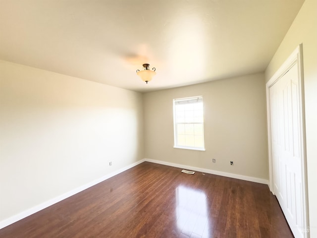 166 Eric Rd, Shoshone, ID 83352 - unfurnished bedroom with dark wood-type flooring and baseboards