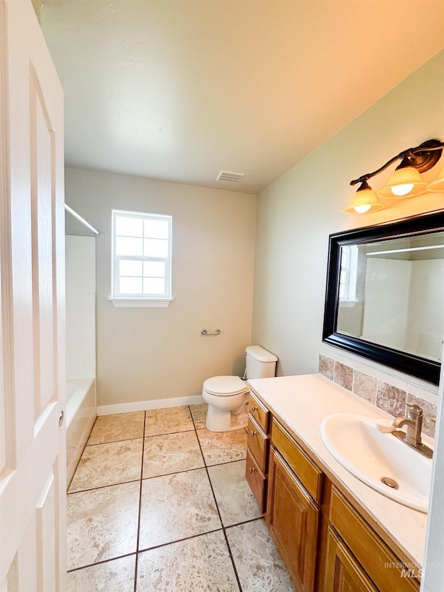 166 Eric Rd, Shoshone, ID 83352 - full bath featuring vanity, toilet, tile patterned flooring, shower / bath combination, and decorative backsplash