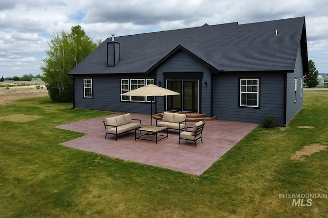 166 Eric Rd, Shoshone, ID 83352 - rear view of house featuring a patio, roof with shingles, and a lawn