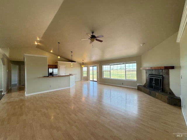 166 Eric Rd, Shoshone, ID 83352 - unfurnished living room with a fireplace, ceiling fan, light wood finished floors, baseboards, and high vaulted ceiling
