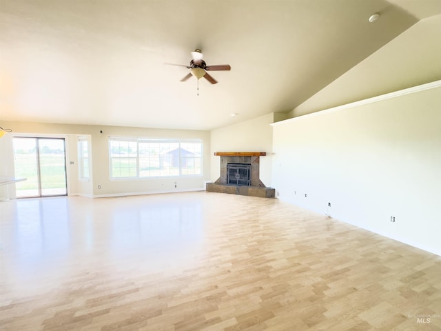 166 Eric Rd, Shoshone, ID 83352 - unfurnished living room with wood finished floors, ceiling fan, a tiled fireplace, baseboards, and high vaulted ceiling