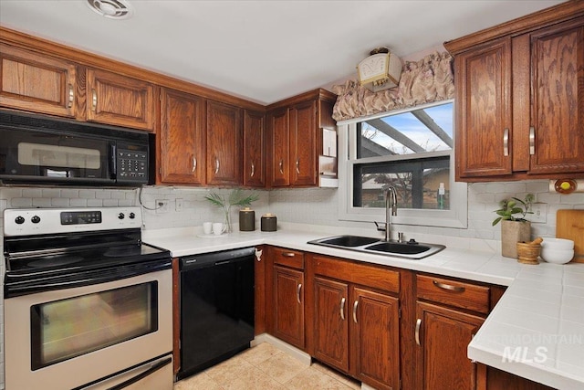 6426 W Fairfield Ave, Boise, ID 83709 - kitchen featuring black appliances, a sink, backsplash, and brown cabinets