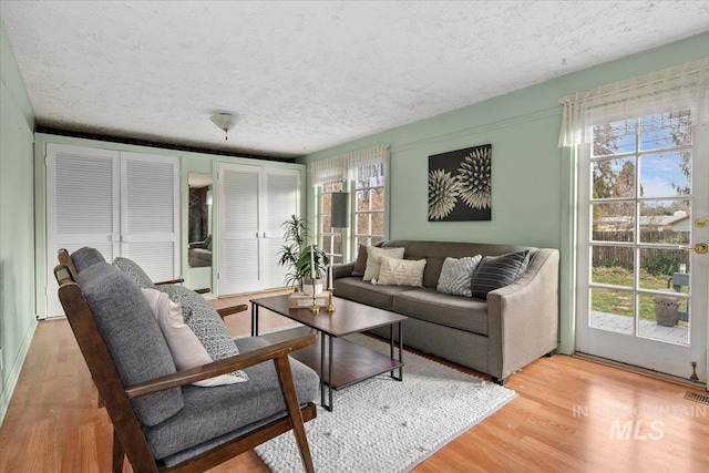 6426 W Fairfield Ave, Boise, ID 83709 - living room with a textured ceiling and light wood-style floors