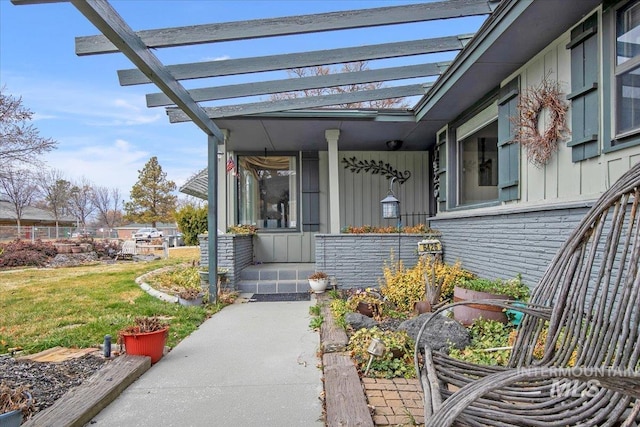6426 W Fairfield Ave, Boise, ID 83709 - view of exterior entry featuring board and batten siding, a yard, a pergola, and a porch