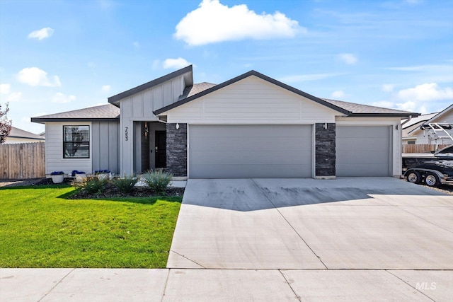 view of front of house featuring a garage and a front lawn