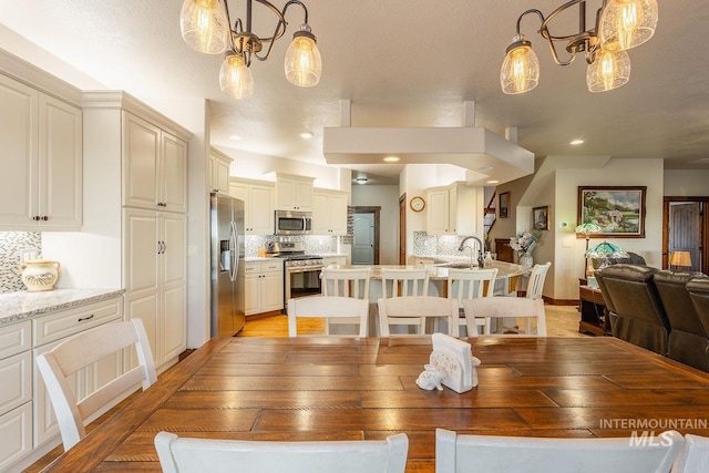 dining area featuring sink and light hardwood / wood-style floors